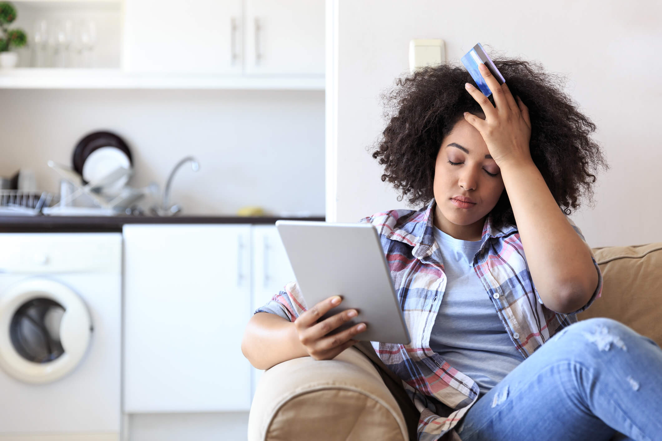 Frustrated woman shopping on couch